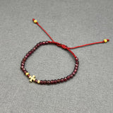 DIAMOND CROSS ON GARNET BEADED BRACELET