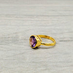 Vibrant round-cut Amethyst Center stone encased in 14k gold and a pounded band. The texture of the band brings in light to enhance the beauty of the stone
14 Kt Yellow Gold
Amethyst
Hand Crafted
available in every size
Round cut