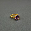 Vibrant round-cut Amethyst Center stone encased in 14k gold and a pounded band. The texture of the band brings in light to enhance the beauty of the stone
14 Kt Yellow Gold
Amethyst
Hand Crafted
available in every size
Round cut